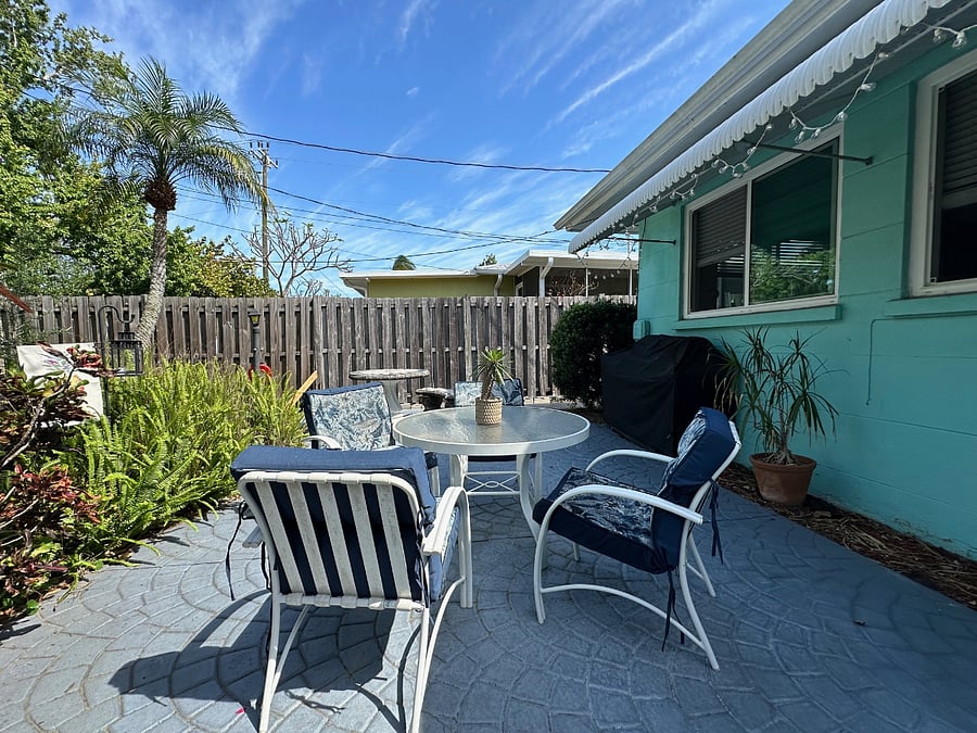 Rear patio, rear fenced yard with side gates.