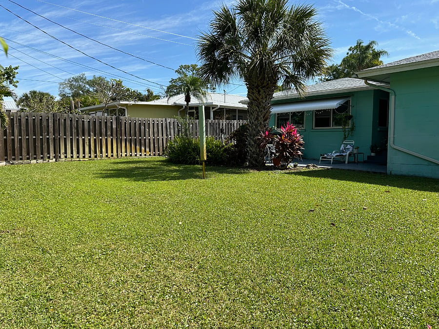 Rear patio, rear fenced yard with side gates.