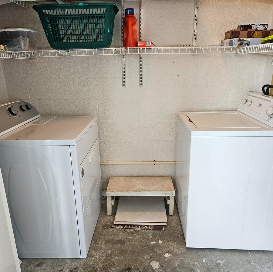 Laundry room. Located at the balcony area. New dryer machine. Has shelves above dryer and washing machines.