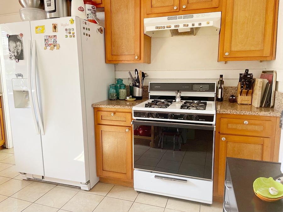 Full refrigerator and gas stove. Kitchen also features a dishwasher, microwave, coffee maker, and full cooking supplies.