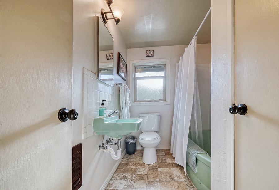 Main bathroom, near bedrooms 1, 2, 3. Bath with shower is upstairs.