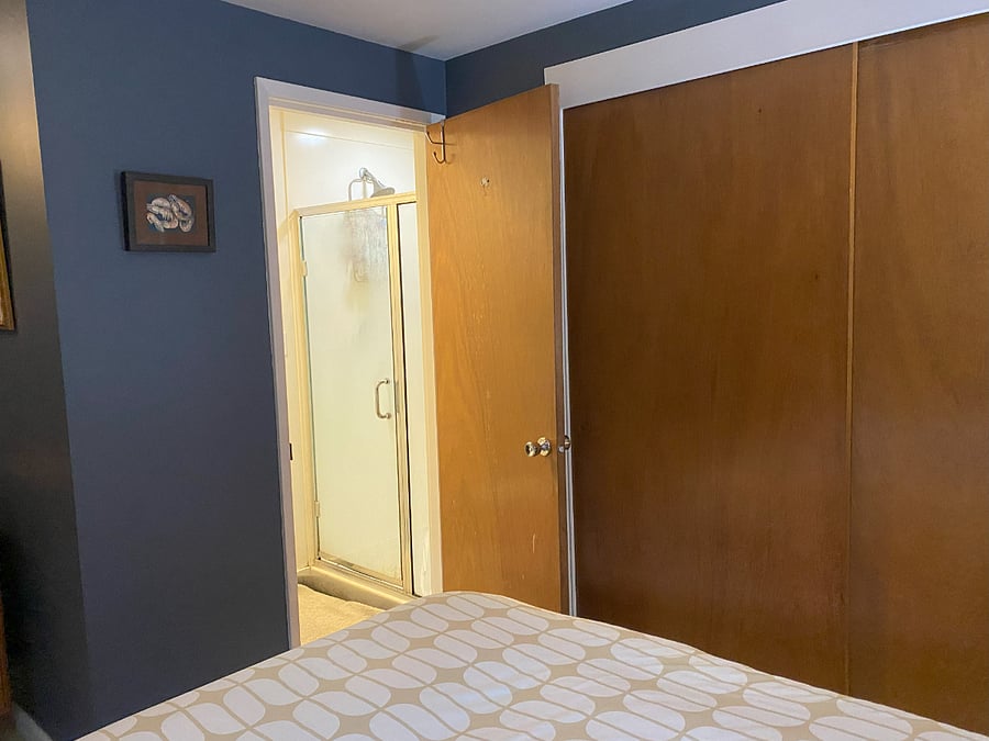 Main bedroom with view to half bath (toilet and shower)