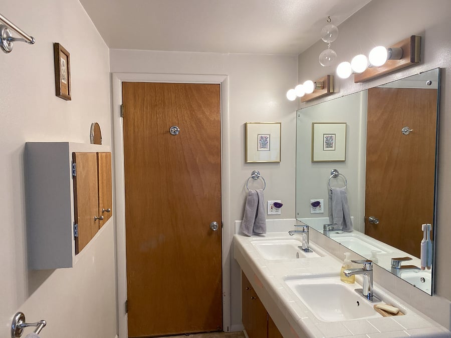 Bright clean bathroom with twin sinks and great storage