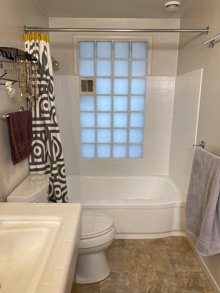Bathroom tub with glass brick wall brightening up the space