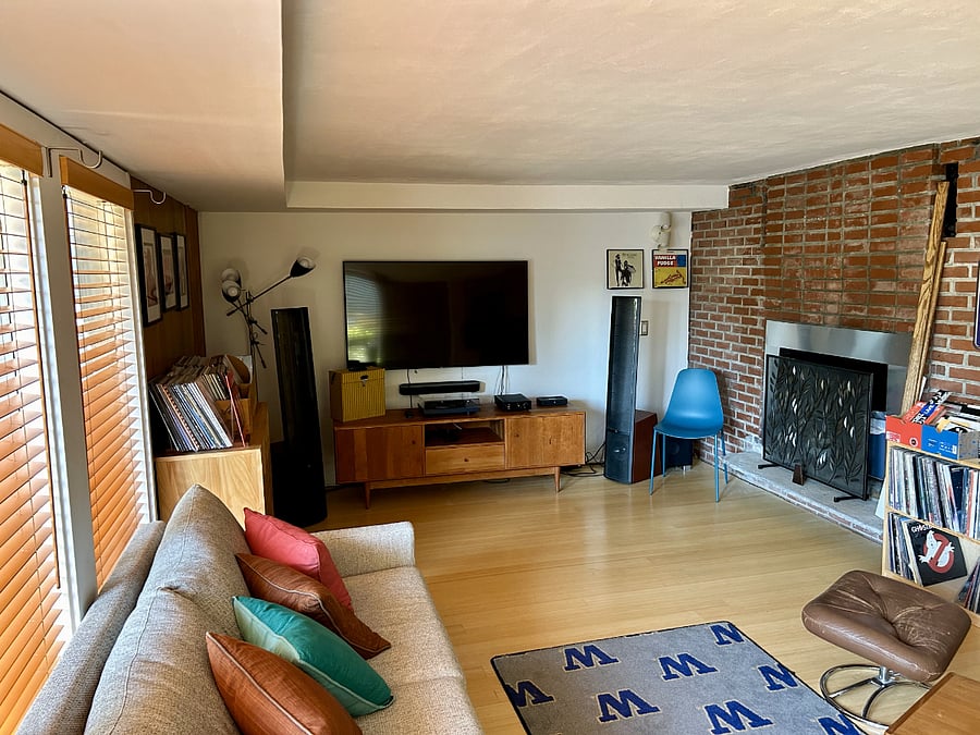 A second living room with workout space and room & board coach with bed.