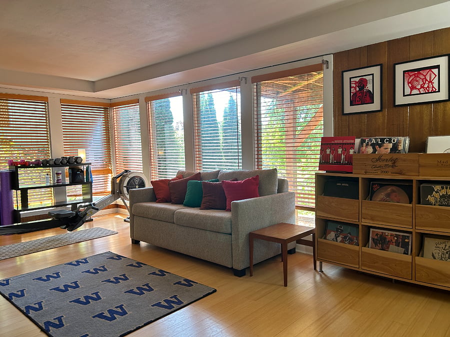 A second living room with workout space and room & board coach with bed. 