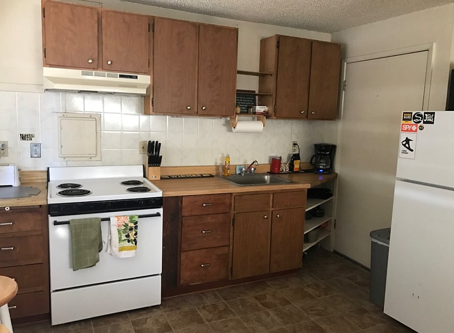 Kitchen with full stove, fridge, pots and pans, coffee pot, grinder, toaster and breakfast bar (3 seats) plus TV trays.