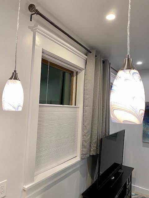 Light filtering top-down bottom-up cellular shades on all 4 windows, along with drapes for additional privacy.