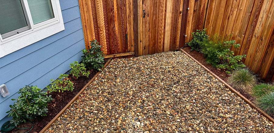 Photo taken 1/2025. The recycling and garbage cans are right outside this back gate.