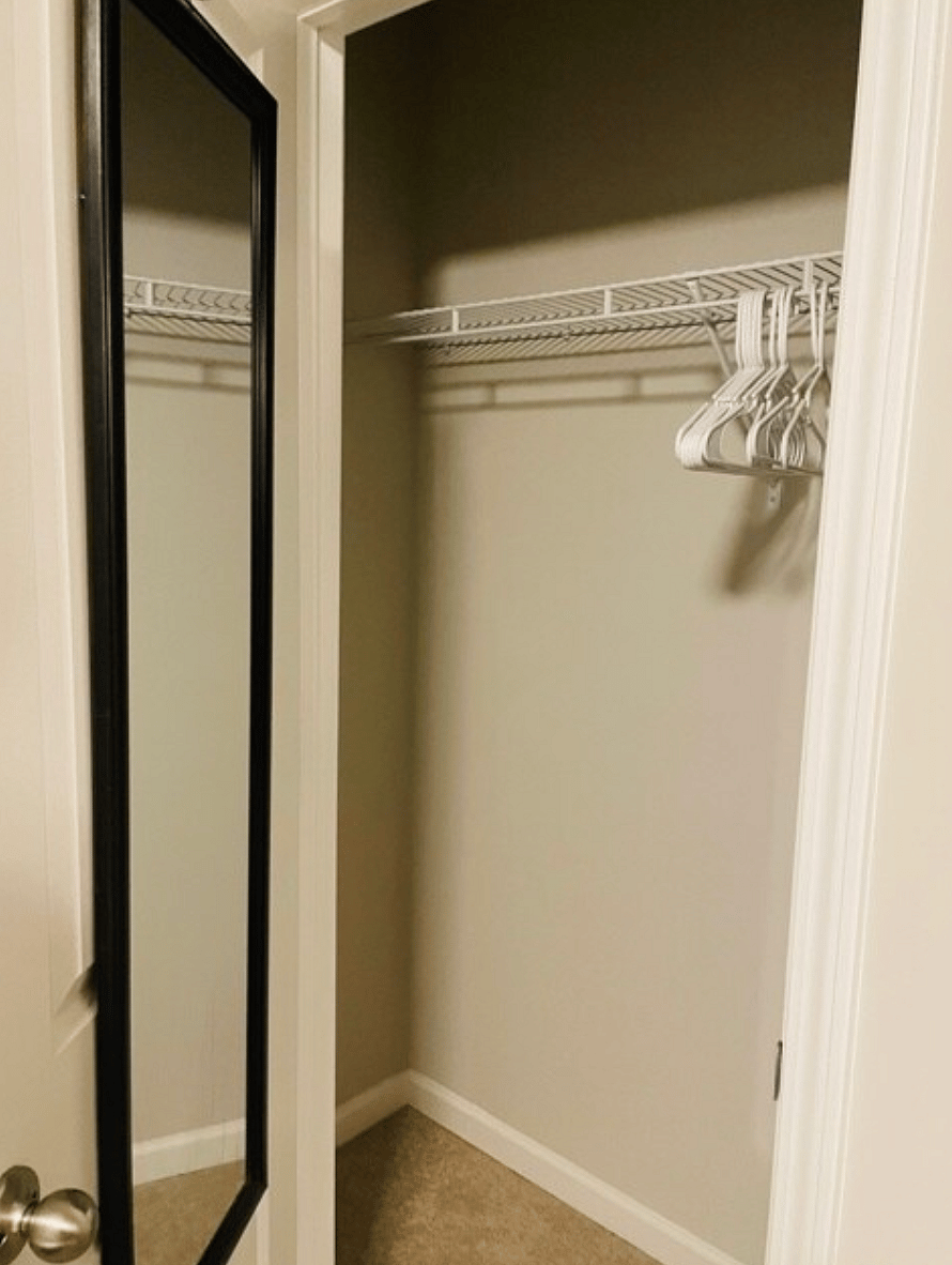Lots of closet space with provided hangers and a full body mirror.
