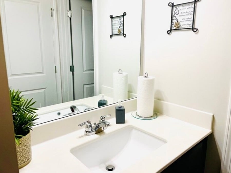 The sink area is separate from the shower/toilet, allowing simultaneous use.

