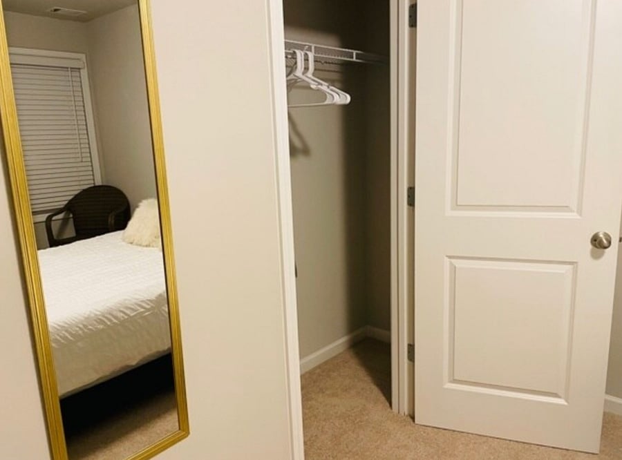 Lots of closet space with provided hangers and a full body mirror.

