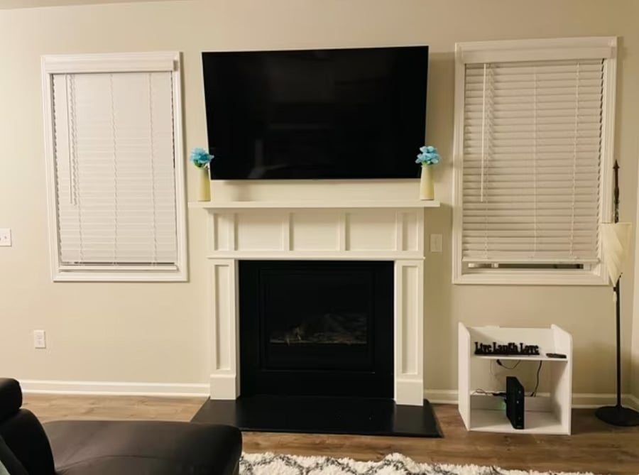 Relax in the living room with a 65 inch smart TV and fireplace

