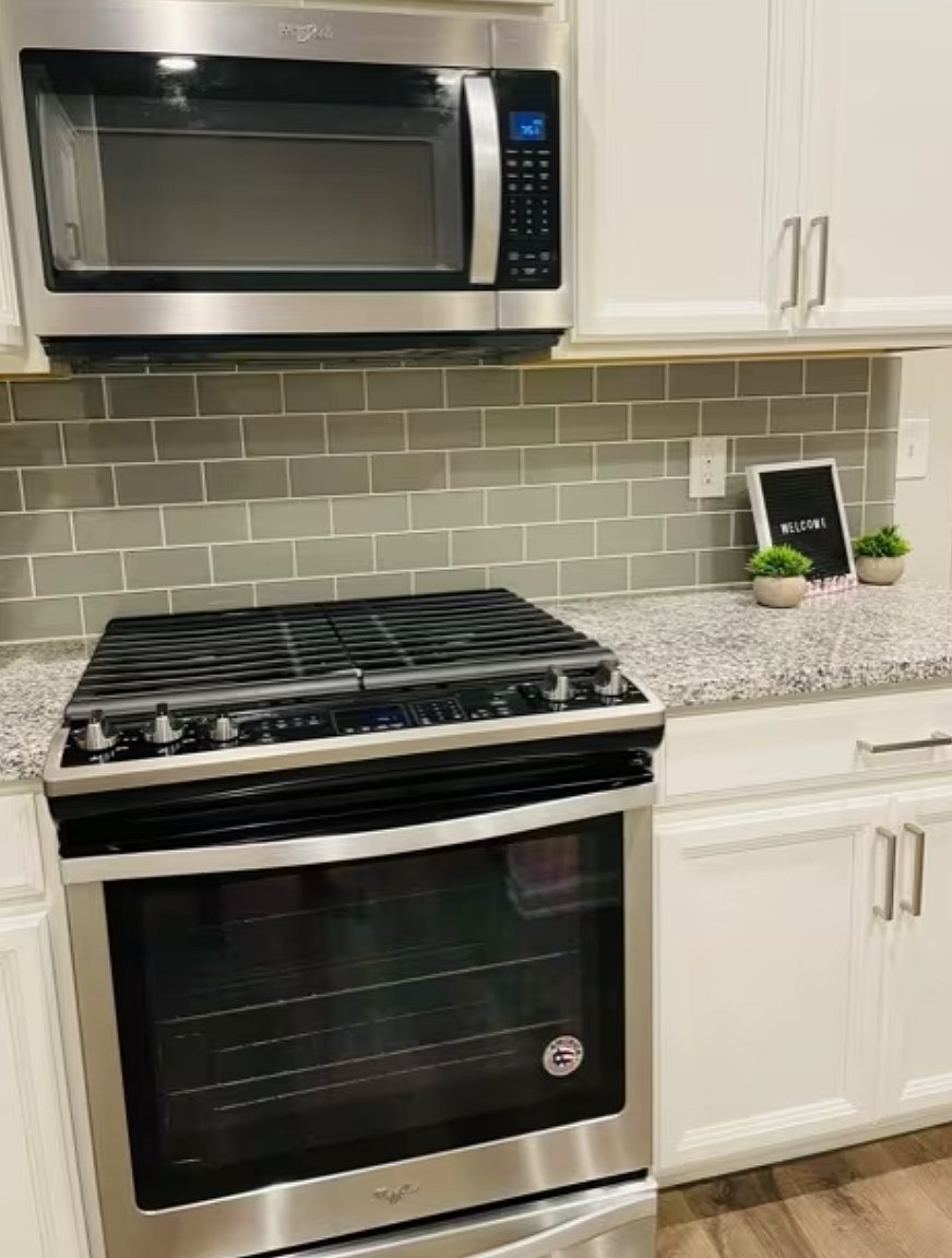 New stainless steel appliances include a backless gas stovetop and oven, as well as a microwave

