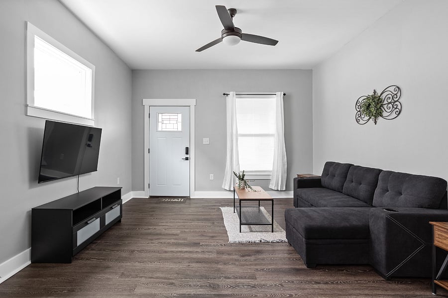 Living room with seating that doubles as a bed, offering both comfort and functionality for your convenience.