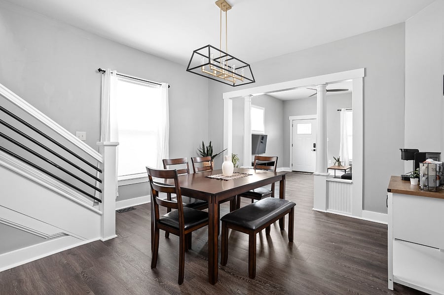 Stairs up to the bedroom on the left, coffee bar on the right and large dining table