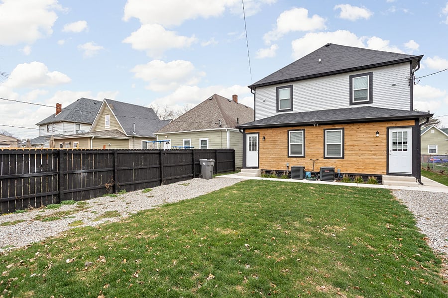 Backyard with fenced-in parking, offering enough space to comfortably fit 1-2 cars for your convenience.