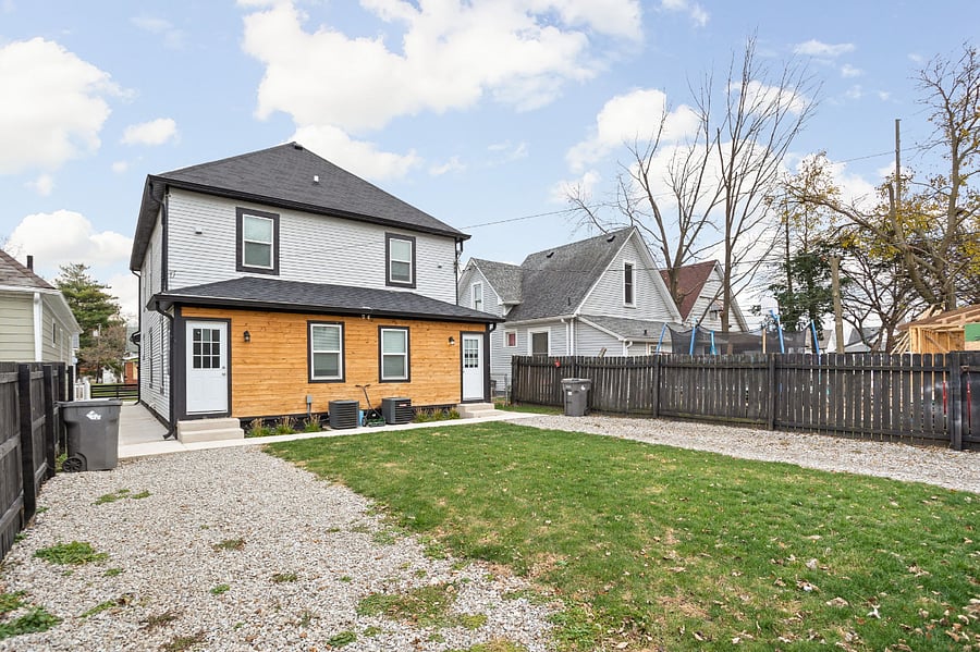 Backyard with fenced-in parking, offering enough space to comfortably fit 1-2 cars for your convenience.