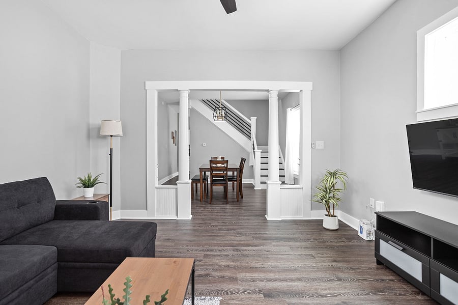 Living room with seating that doubles as a bed, offering both comfort and functionality for your convenience.