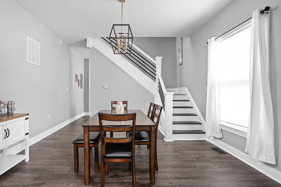 Stairs up to the bedroom on the left, coffee bar on the right and large dining table