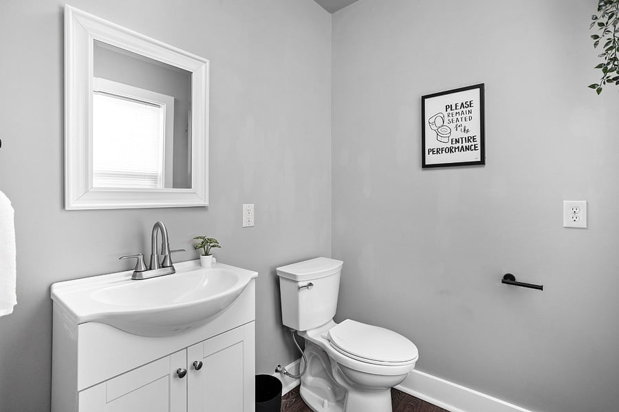 Downstairs half bathroom conveniently located off of the kitchen, offering easy access and added convenience.