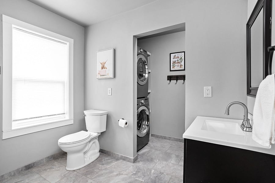 Bathroom with attached Laundry room with washer and dryer, ironing/folding station and provided detergent and softener for your convenience!