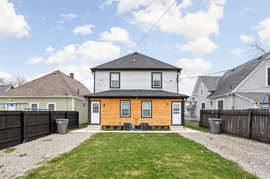 Backyard with fenced-in parking, providing enough space to comfortably fit 1-2 cars.