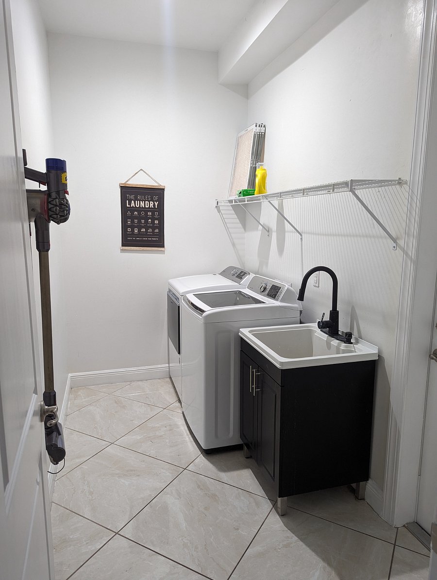 Laundry room with washer, dryer and sink. Access to garage.