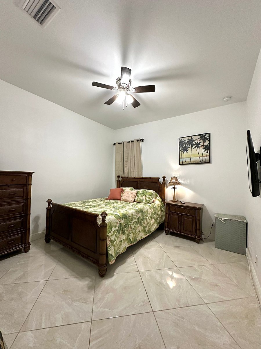 2nd Bedroom with queen bed, dresser and smart television.