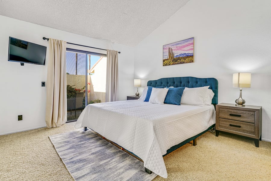 Primary bedroom with KING size bed, plenty of closet space and private patio.