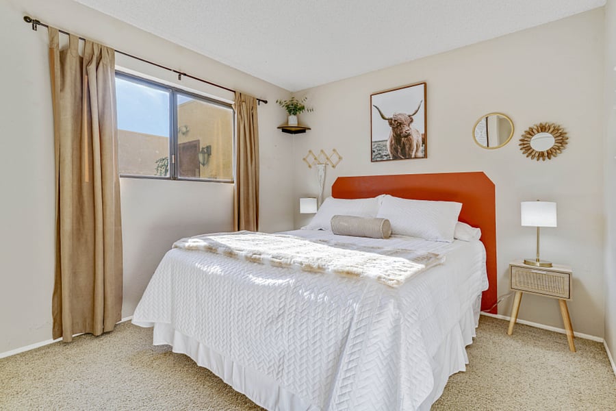 The guest bedroom features a comfortable queensize bed and a light, bright atmosphere, complemented by blackout curtains for a restful nights sleep.