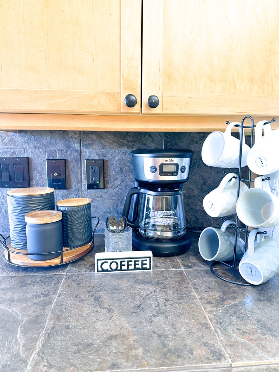 Coffee station including coffee pot, coffee pod maker, filters, coffee, tea assortment, hot chocolate, sugar, cream and of course, mugs.
