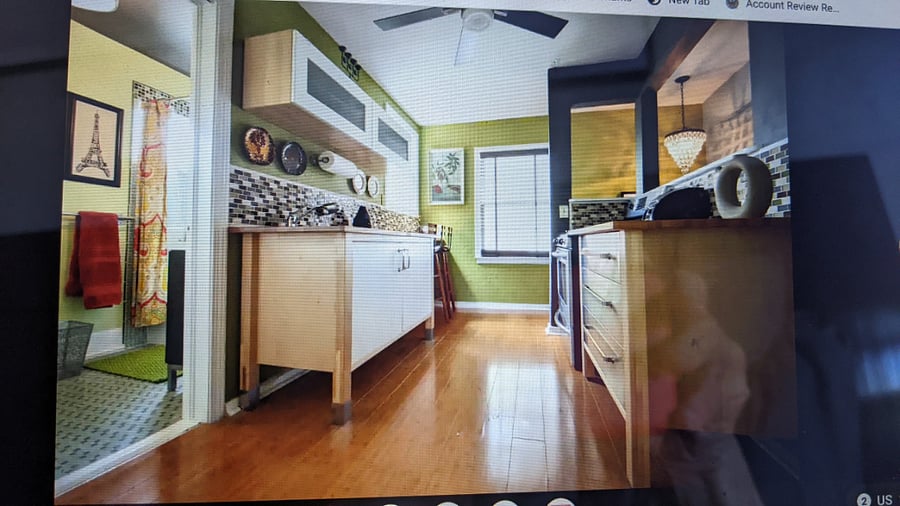full size kitchen with oven and full size refrigerator.  bathroom to the left of the kitchen