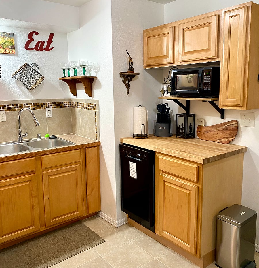 Microwave, Dishwasher and butcher block, with utensil carousel and Charcuterie board.