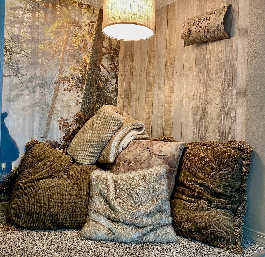 Comfy pillows and throw make the Bear Cave an inviting place to spend an afternoon.