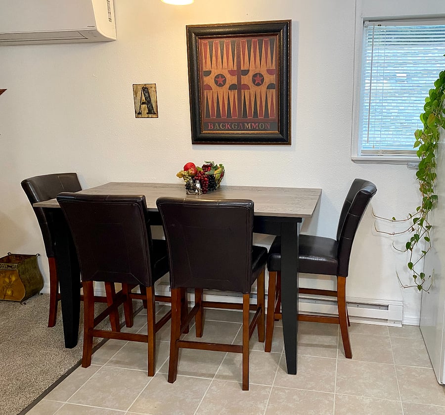 Eat, play games, or just chit chat at the hand-made and stenciled dining table, next to the full sized refridgerator.