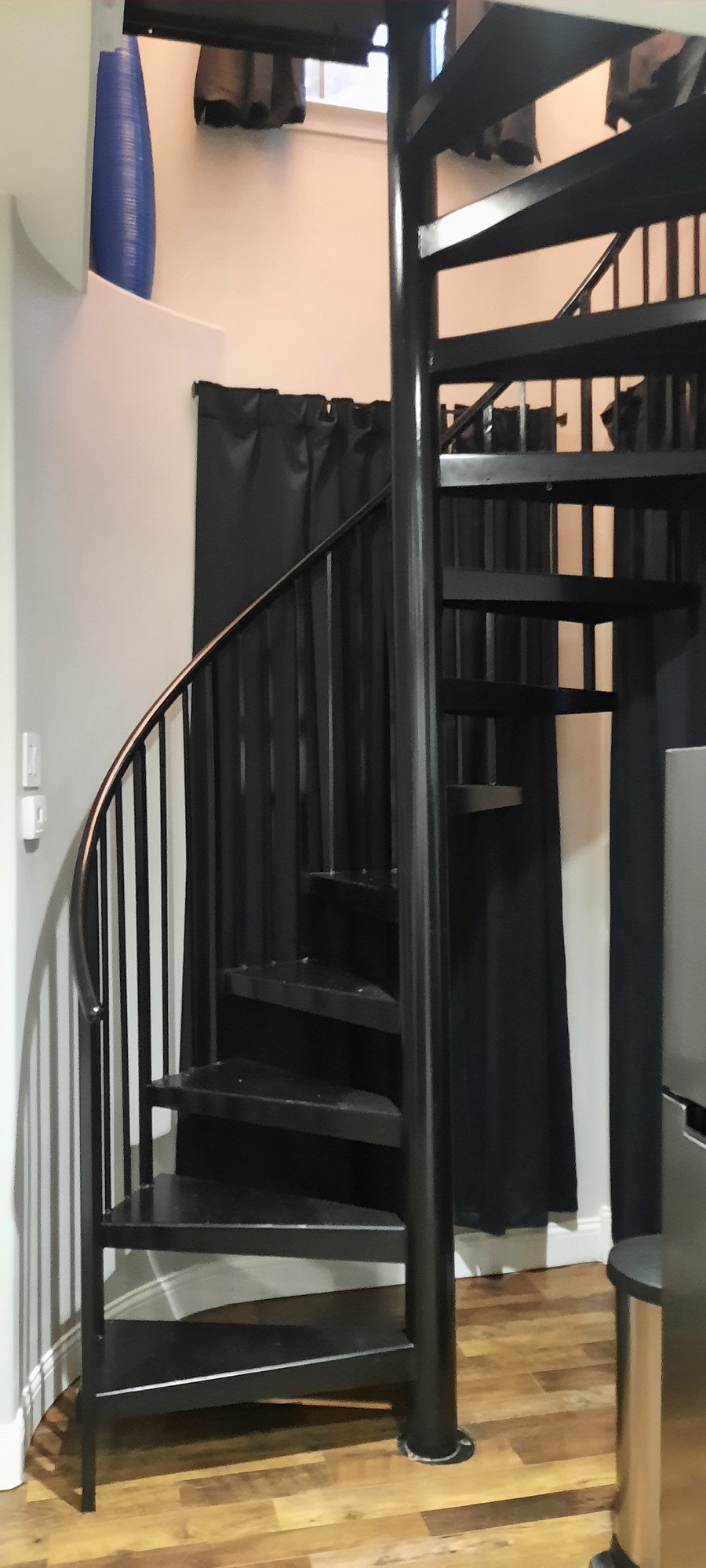 Spiral staircase leading to bedroom/bathroom.