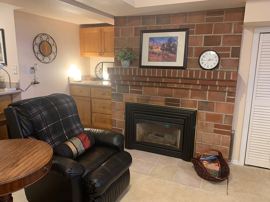 Built-in dresser and grooming area beside fireplace