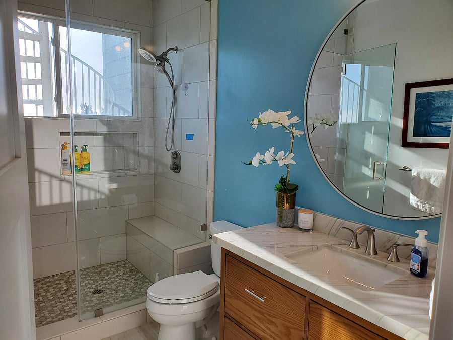 Luxury bathroom with vanity storage and walk-in bay/ocean view from shower