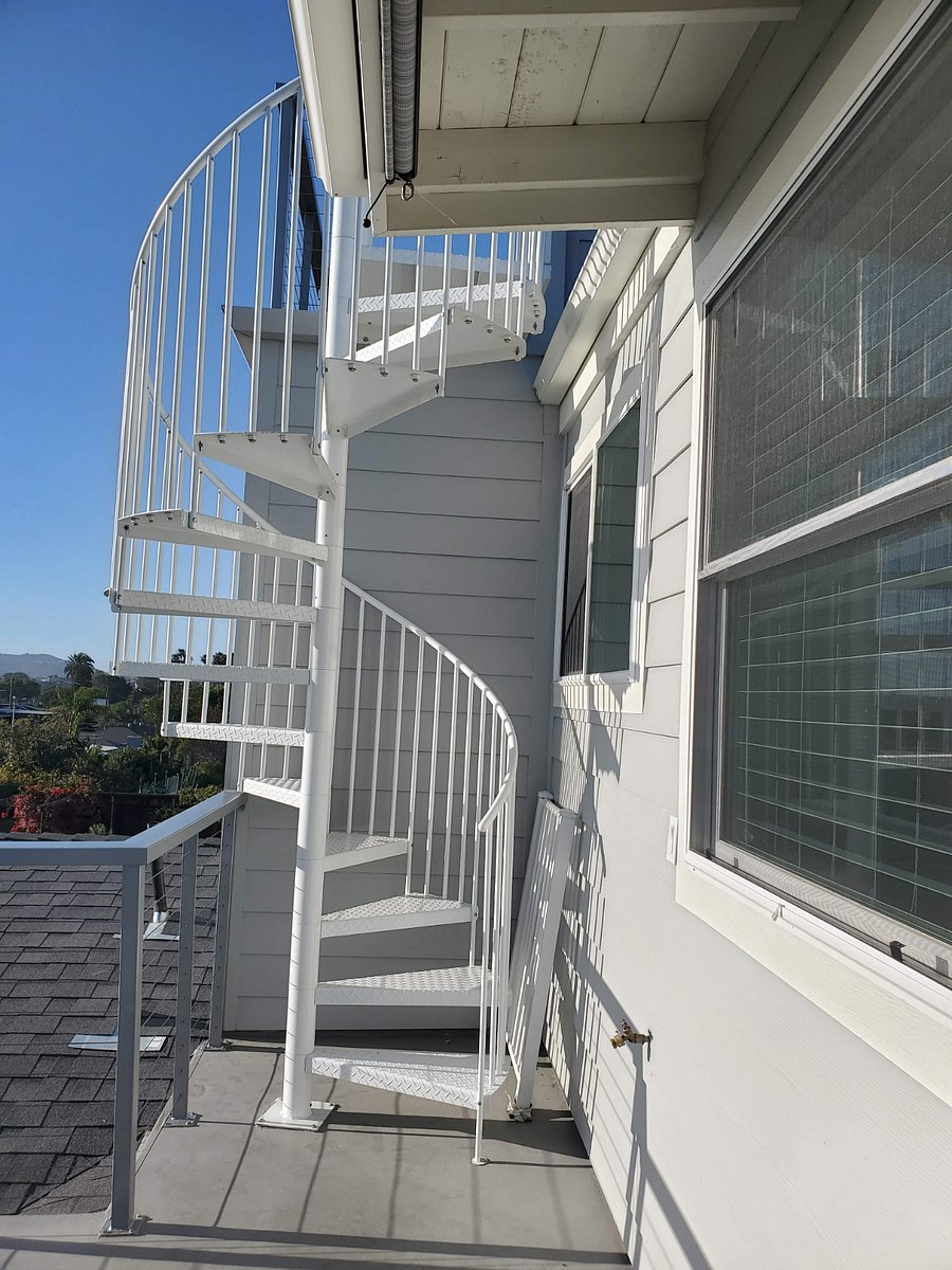 Spiral staircase from living area deck up to rooftop deck