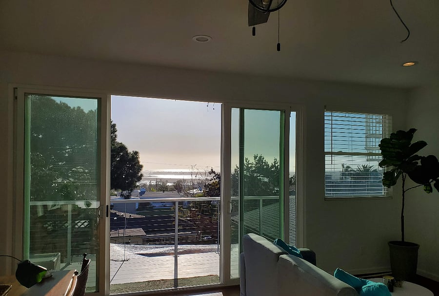 Living area glass sliders leading to exterior decks