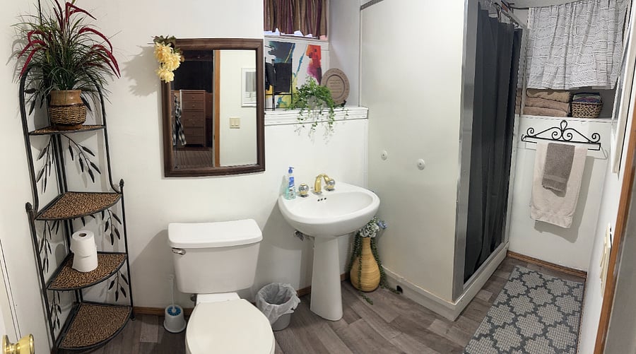 Additional full bathroom located through the laundry room.