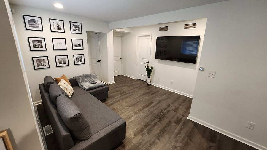 Living Room with 65" TV and convertible Queen sofa bed.
