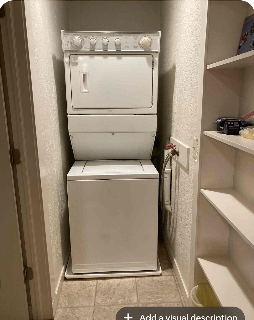 laundry area with stacked washer and dryer.