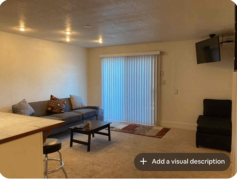 Living room with mounted TV and lounge chair.