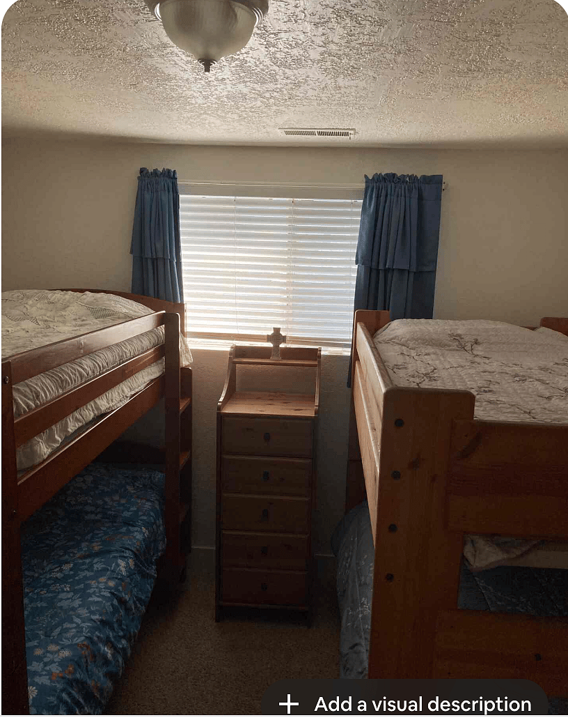 Bedroom with 2 sets of bunkbeds, dresser and closet.
