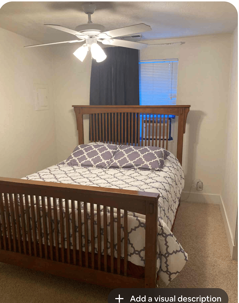 Master bedroom with queen bed and mounted Roku TV.
