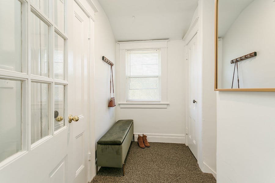 Mudroom at top of stairs with 2 closets for storage