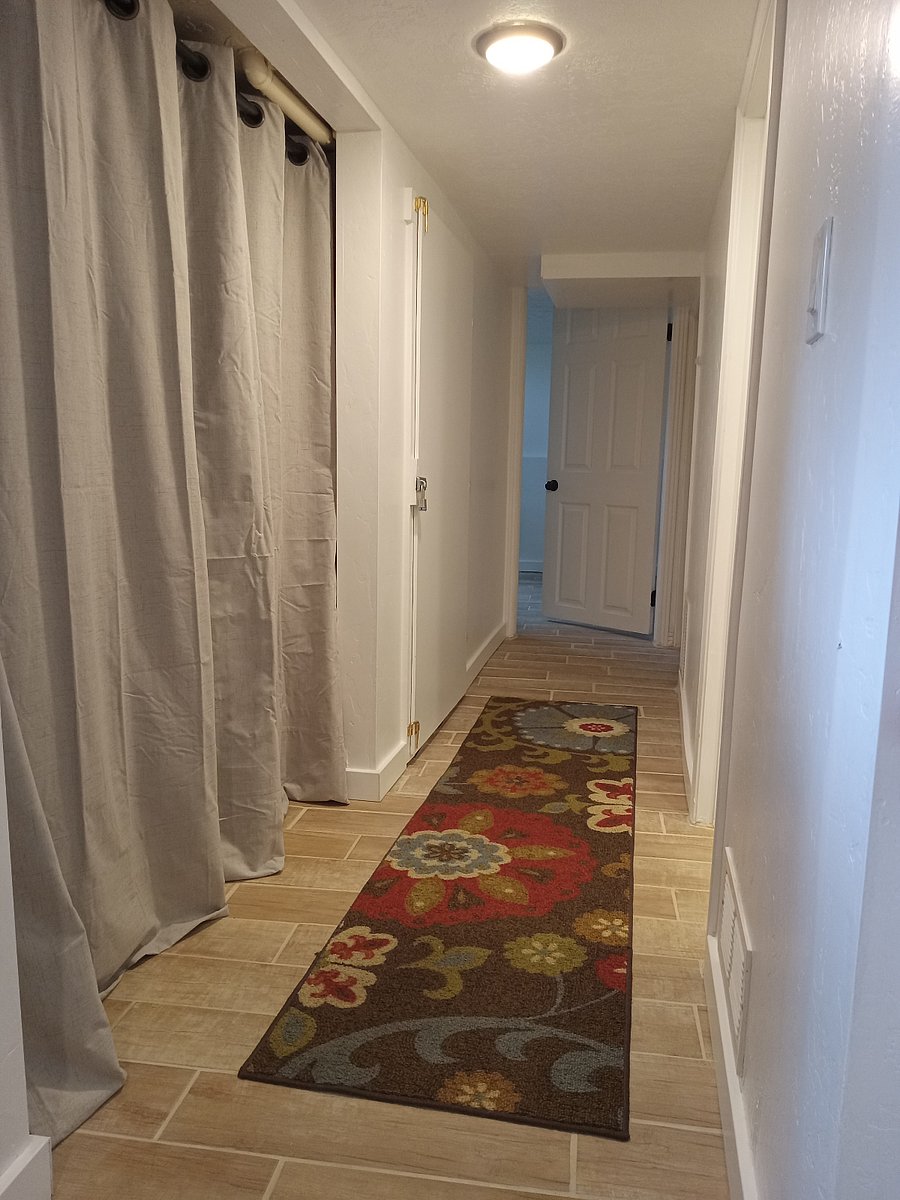 Hallway to second bedroom with laundry to the left behind the curtain2