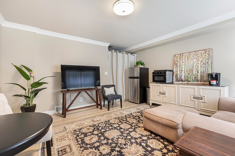 Comfortable and spacious Great Room with Smart TV, table & chairs, sofa & ottoman 